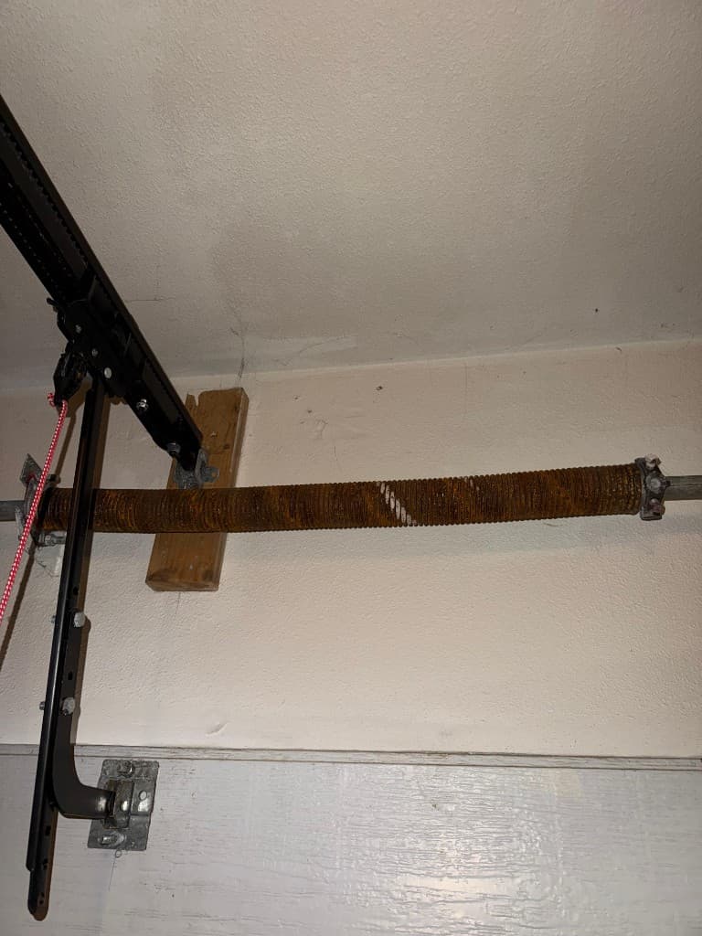 Broken garage door torsion spring before repair garage door comparison in Portland, OR